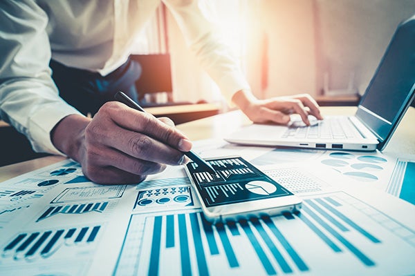 accountant or financial expert analyze business report graph and finance chart at corporate office.