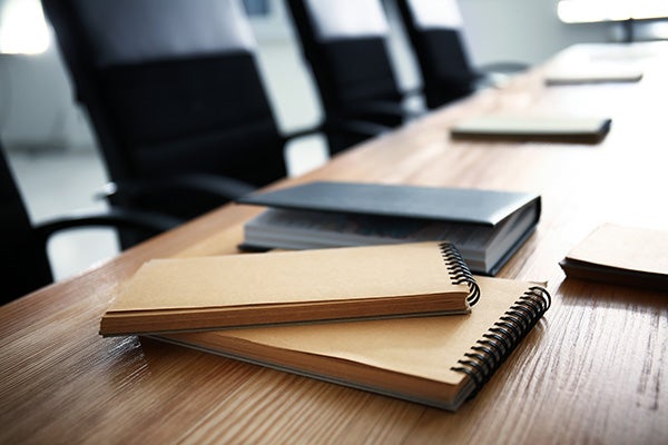 Notebooks on table indoors. Business meeting in conference hall